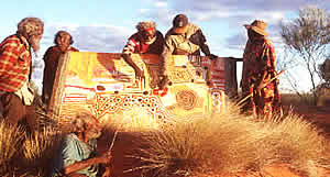 Balgo artists with large painting